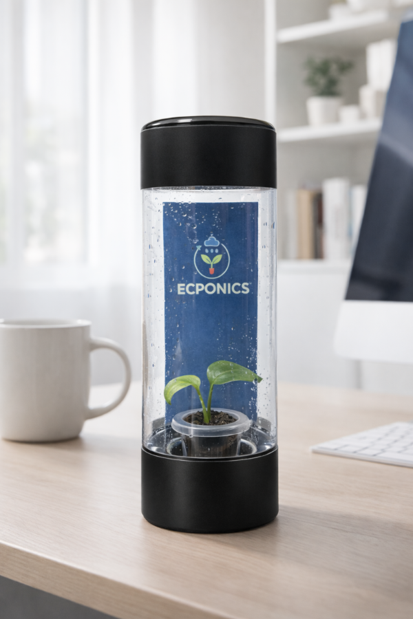 Ecoponics hydroponic system on a desk with a cup and computer in the background